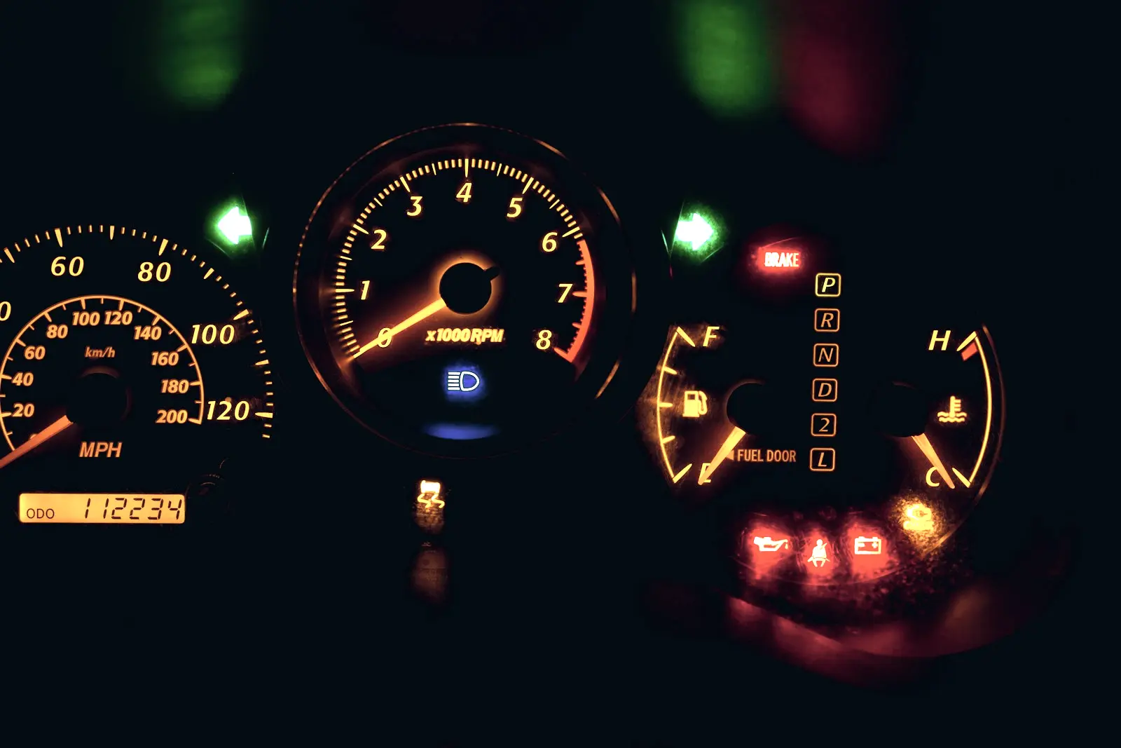 Instrument cluster at night with the brake, oil pressure, battery and check engine warning lights all lit at once.